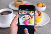 İstanbul, Turkey - January 26, 2016: Woman hands holding an Apple iPhone 6 and taking photos of a food with Instagram application. iPhone is a touchscreen smart phone produced by Apple Inc.